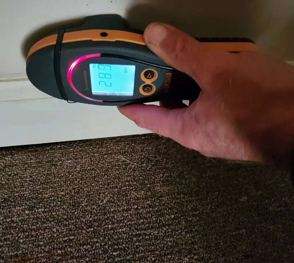 Moisture detection at baseboard during Storm Damage Restoration in Sidney